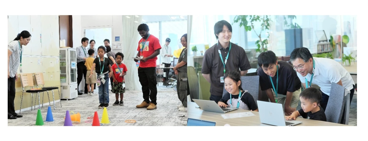 オフィスのような場所で、子供たちが大人と一緒にゲームやノートパソコンを使った学習活動に参加している様子。交流と学びのイベントが開催されている。